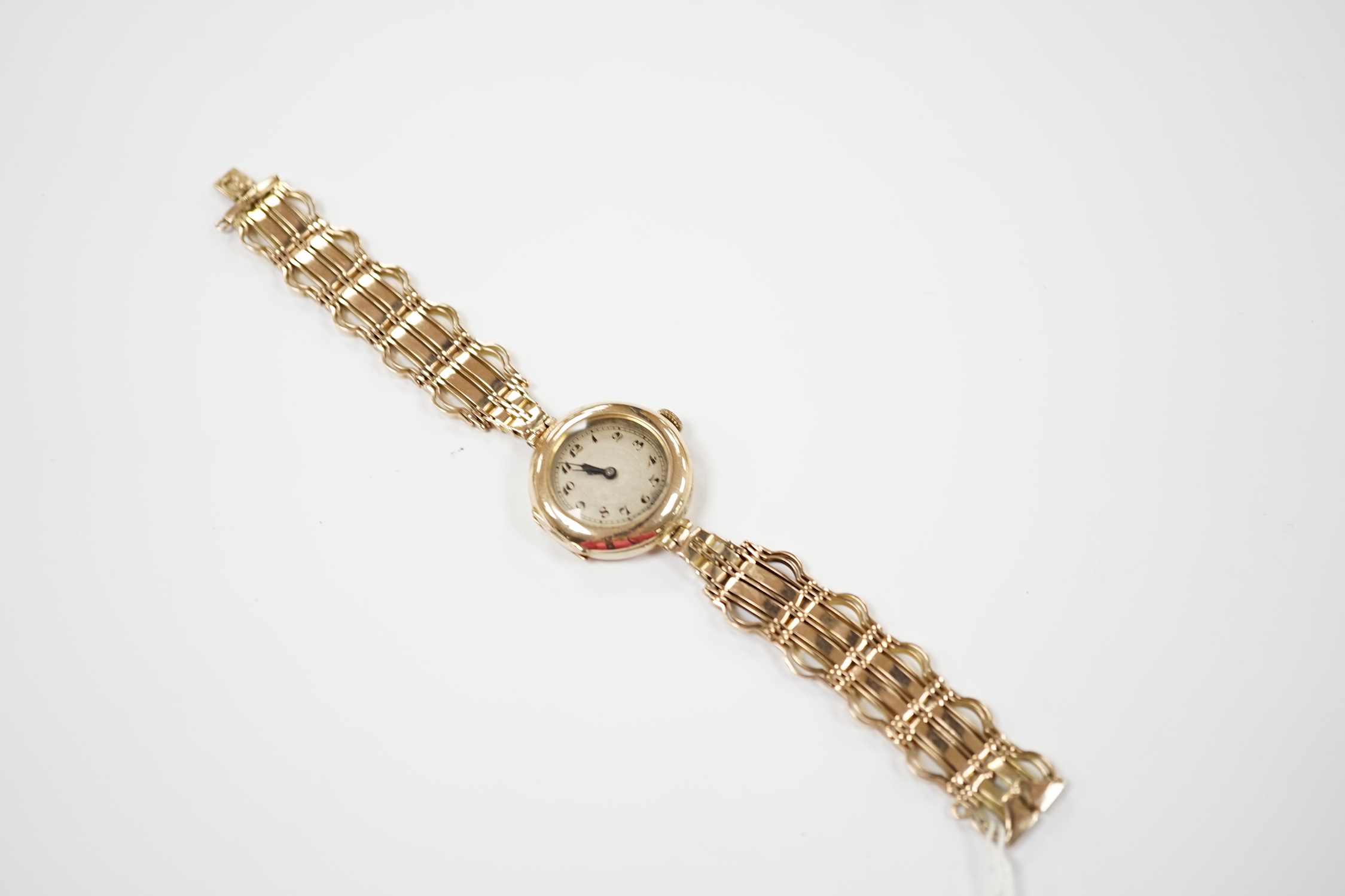 A lady's early to mid 20th century 9ct gold manual wind wrist watch(a.f.), on a yellow metal bracelet